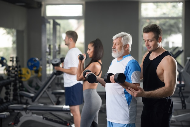 view of lot of people on daily training in gym.