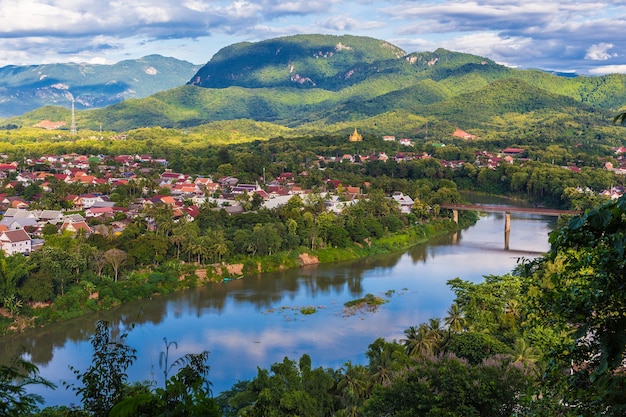 View of Luang Prabang and Nam Khan river in Laos with beautiful sunset light bathing the mountains