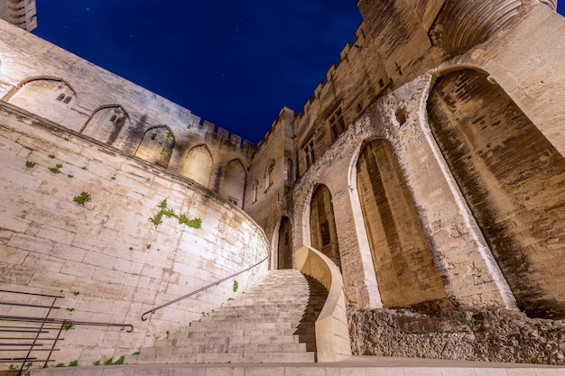 View of main staircase of Palace of the Popes at night in Avignon city.