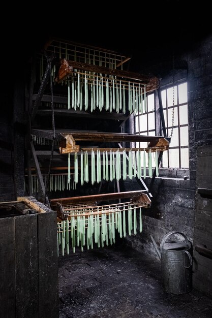 Photo view of making green tallow candles the victorian way using a dipping donkey machine