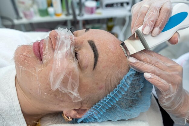 View of making a moisturizing nourishing mask for a client's face in a beauty salon