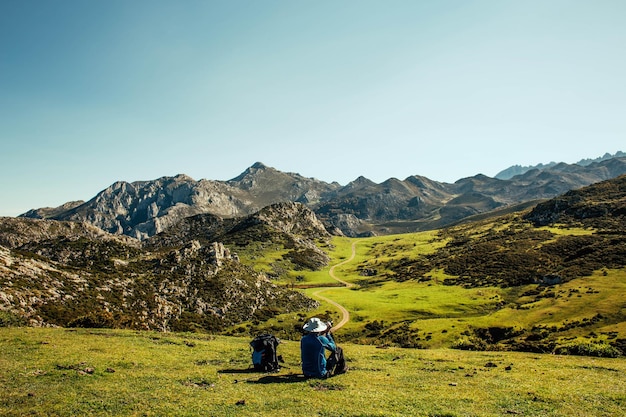 view of a man siting on mountain landscape