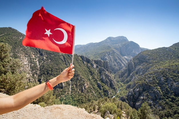 view of a Manastir mountain canyon and turkish flag in hand