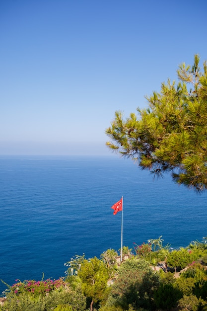 A view of the Mediterranean coast with waves of azure water. Summer seascape. Seaside in sunny weather. Beautiful sea view