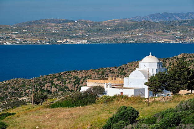 View of milos island and greek orthodox traditional whitewashed church in greece