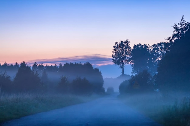 View of misty road after sunset