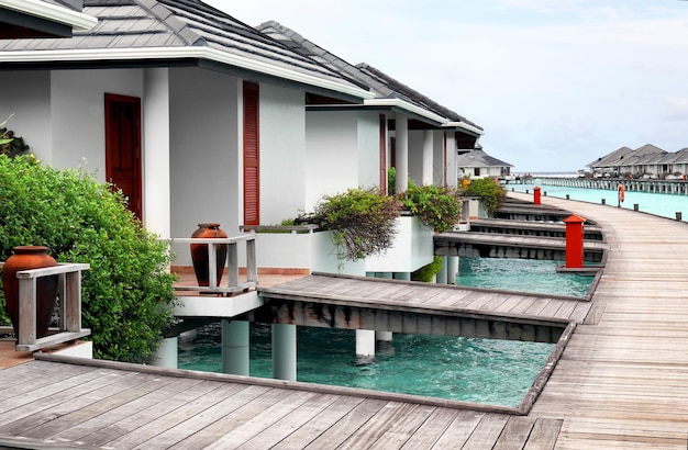 View of modern beach houses on piles at tropical resort