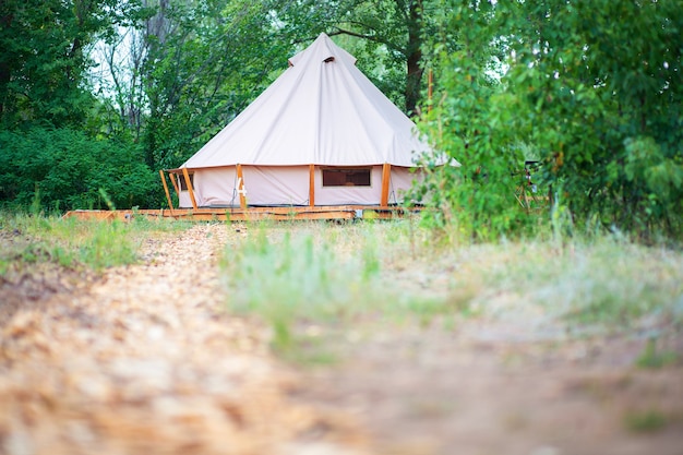 View of modern camping tents in the glamping area. Camping tent with all the amenities.