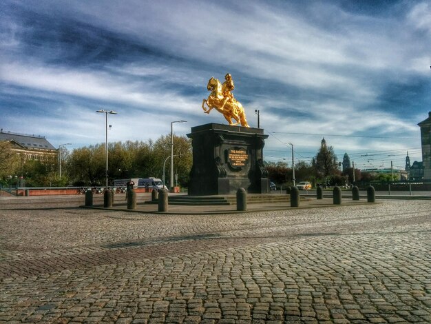 Photo view of monument on cobblestoned square