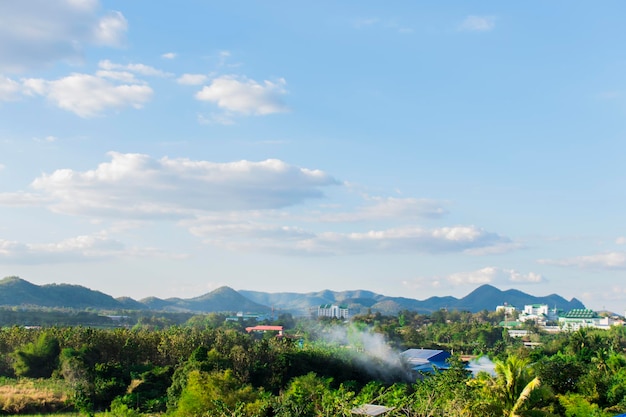 View of mountains and green trees against the blue sky.