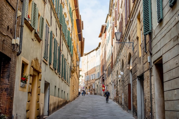 View on narrow and cozy street in siena italy