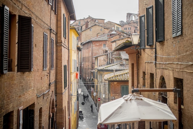 View on narrow and cozy street in siena italy