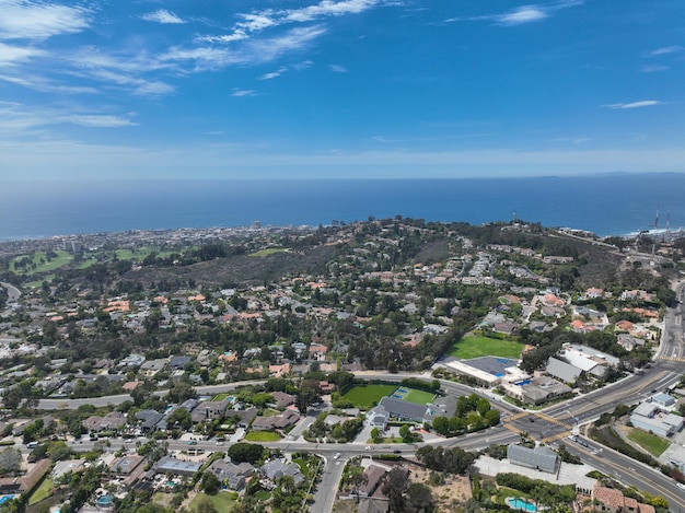 A view of a neighborhood with a blue sky and a few clouds