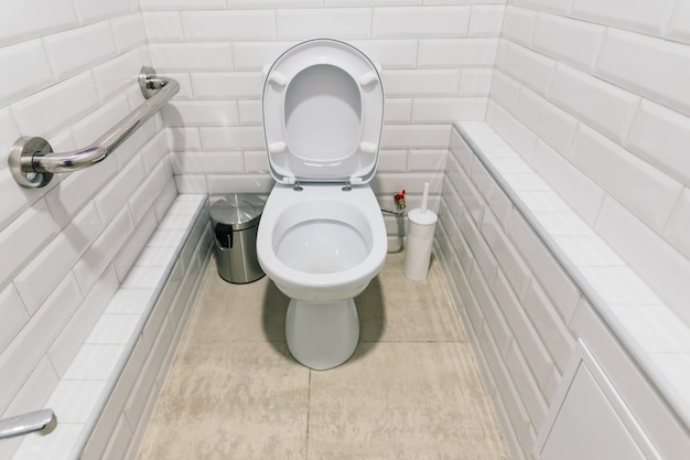 View of a new toilet and bathroom interior for hospital, white and clean