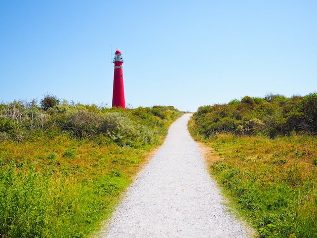 View of the North Tower - lighthouse in Schiermonnikoog islands one of the Frisian Islands, on sand dune against blue sky