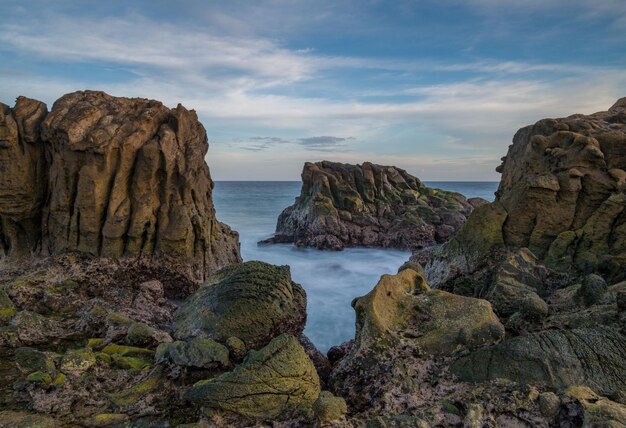 A view of the ocean from the rocks at the beach