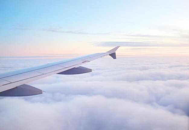 사진 해가 지는 동안 구름 위 에 있는 비행기 날개 의 모습