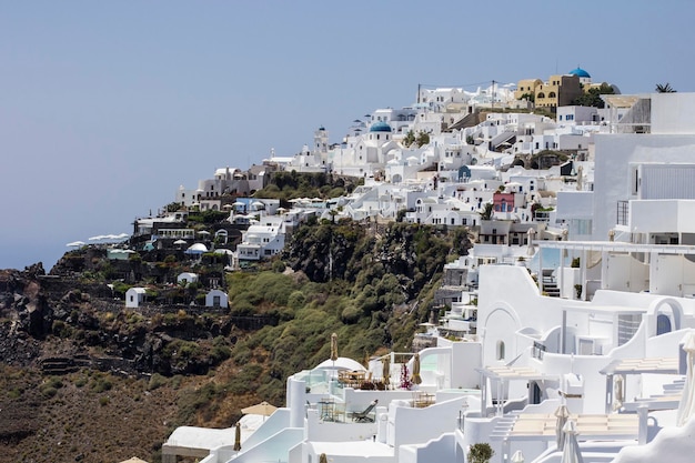 View of Oia town with white houses and windmill at Santorini island, Greece