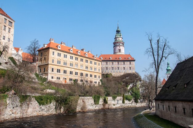 View of old building by river against sky