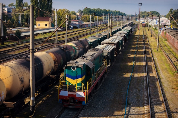 View of the old dusty railway with freight cars and power lines