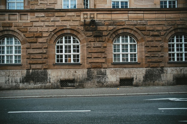 View of old glass windows against a facade wall along the street