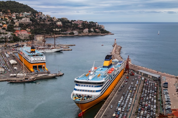 view of the old port of Nice France big cruise liners and parked cars at the dock