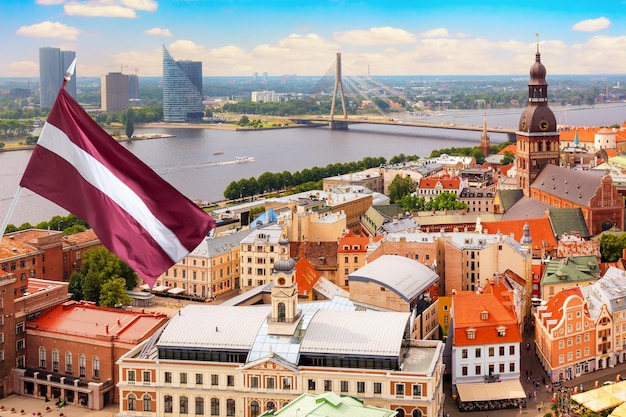 View of the Old Town Ratslaukums square, Roland Statue, The Blackheads House and St Peters Cathedral against blue sky in Riga, Latvia. Summer sunny day.