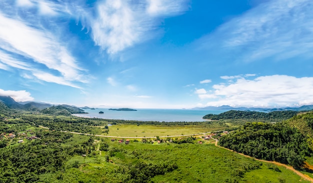 View over in the Paraty, the beach and blue ocean. Green forest