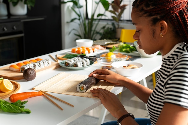 Photo view of people learning how to make traditional sushi dish