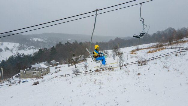 View of people at ski lift chair winter season