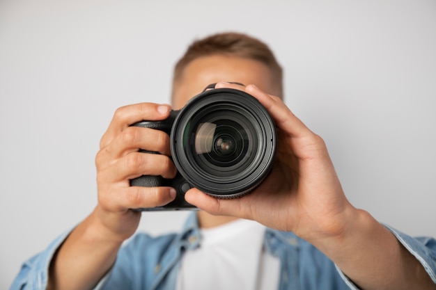 Photo view of person holding professional digital camera