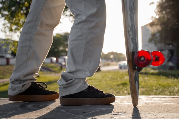 Photo view of person using skateboard with wheels outdoors