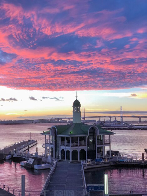 View of pier over sea against sky during sunrise