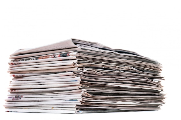 View of a pile of newspapers stacked isolated on a white background.