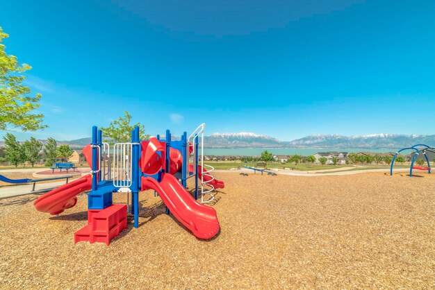 View of playground against clear blue sky