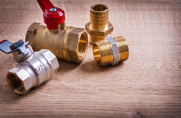 View Plumbing Tools Brass Pipe Connectors On Wooden Board Close Up