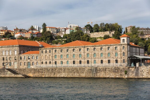 View of Porto city at the riverbank Ribeira quarter and wine boatsRabelo on River DouroPortugal a UNESCO World Heritage City