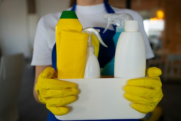 View of professional cleaning service person holding supplies