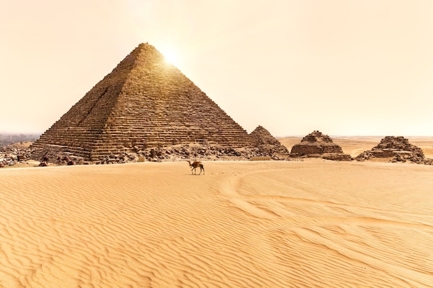 Photo view on the pyramid of menkaure and three small pyramids in giza, egypt.