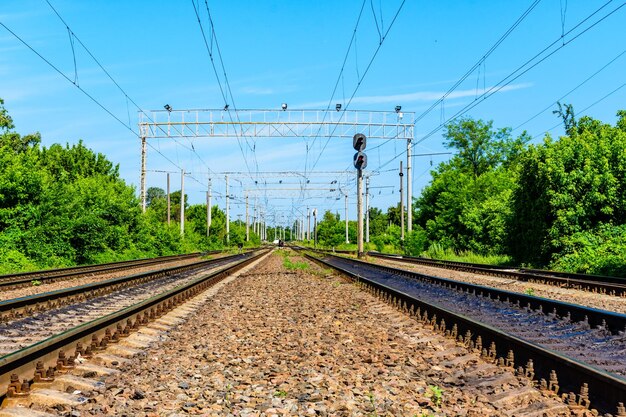 View on a railroad track and white clouds in a blue sky