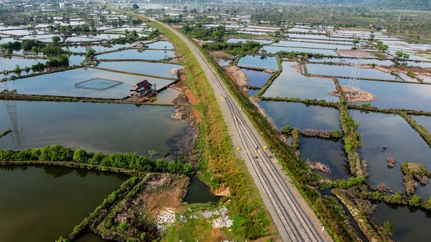 View of railway tracks and rice fields in the countryside in indonesia