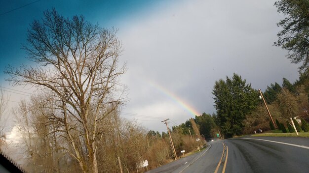 View of rainbow over road against sky