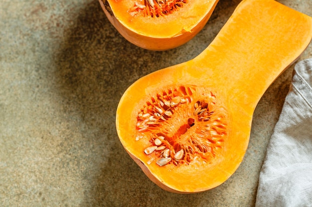 View on raw halves of butternut squash on a kitchen table Seasonal vegetable food still life