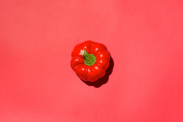 Above view of red bell pepper on red background.