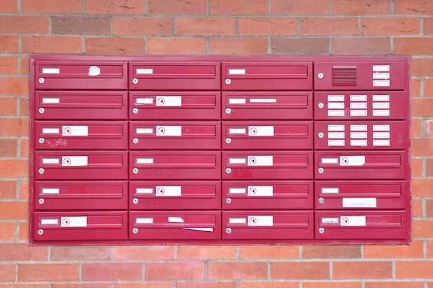 View of red mailboxes on brick wall