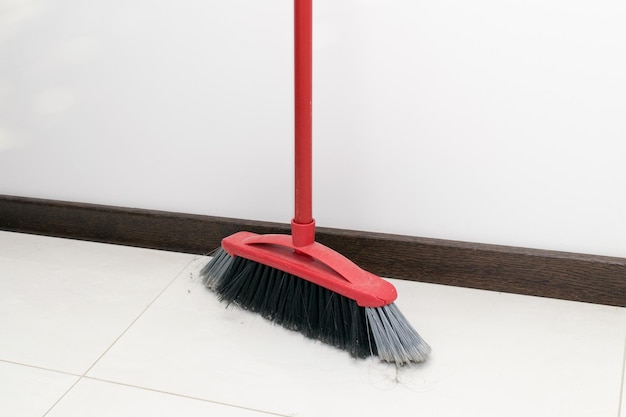 Photo view of the red sweeping brush in the kitchen