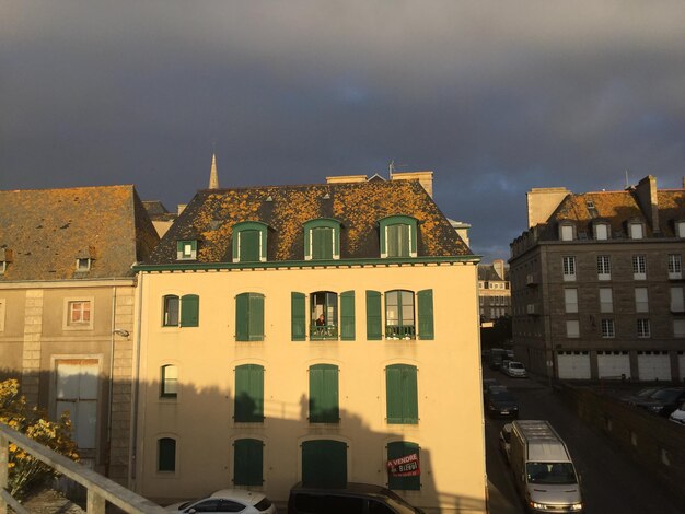 View of residential buildings against cloudy sky