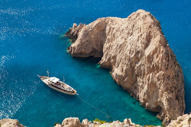 View of the rock and tourist boat in azure water from the top Lefkada island Greece