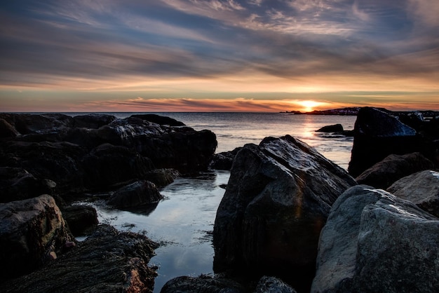 View of rocky beach at sunset