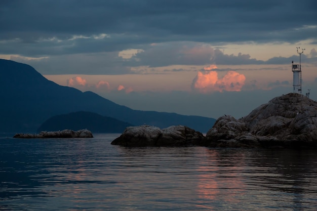 View of rocky islands with birds during sunset